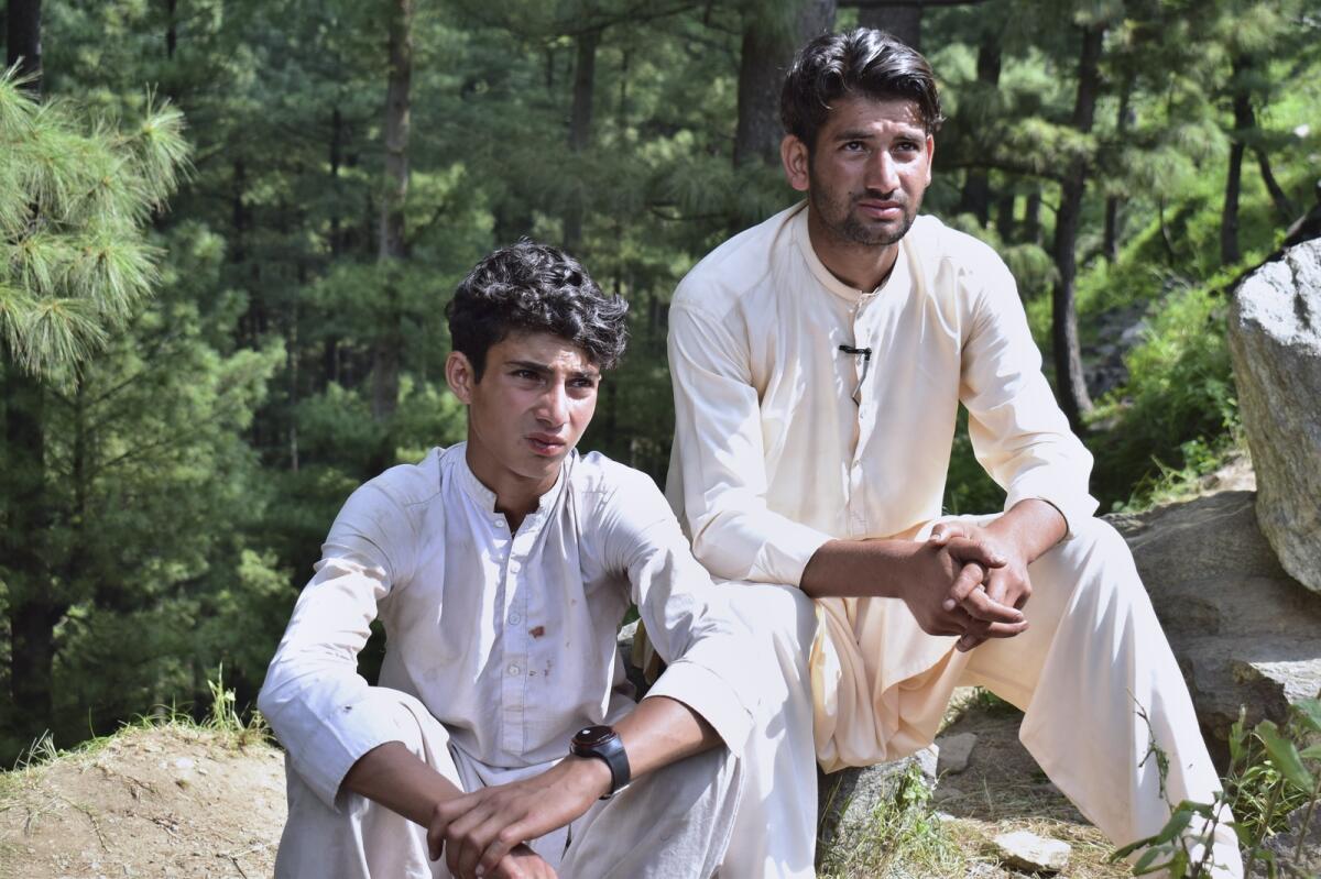 Abrar Ahmed (left) a survivor of the cable car incident. — AP