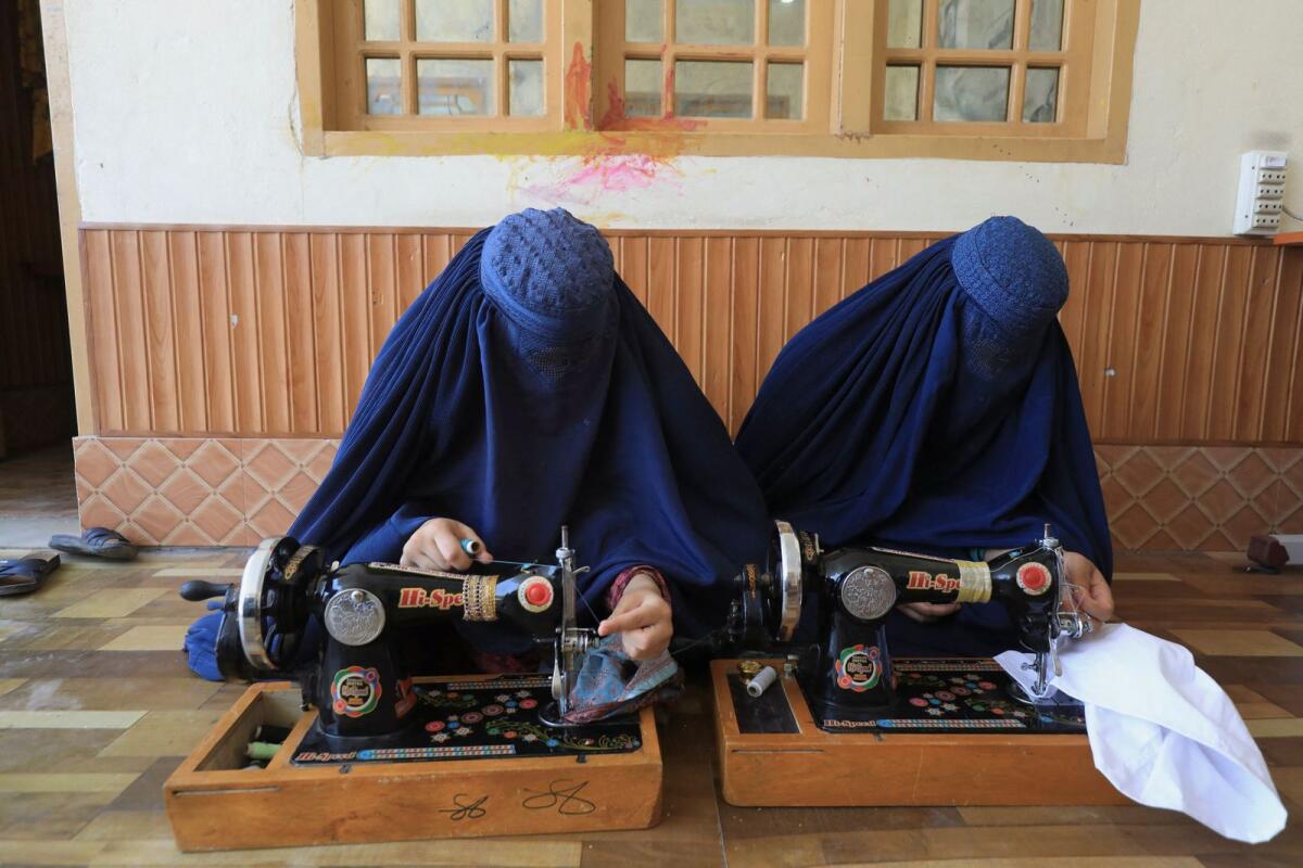 Afghan women attend tailoring class at the Skills Academy for Needy Aspirants in Peshawar, Pakistan, July 13, 2023. — Reuters