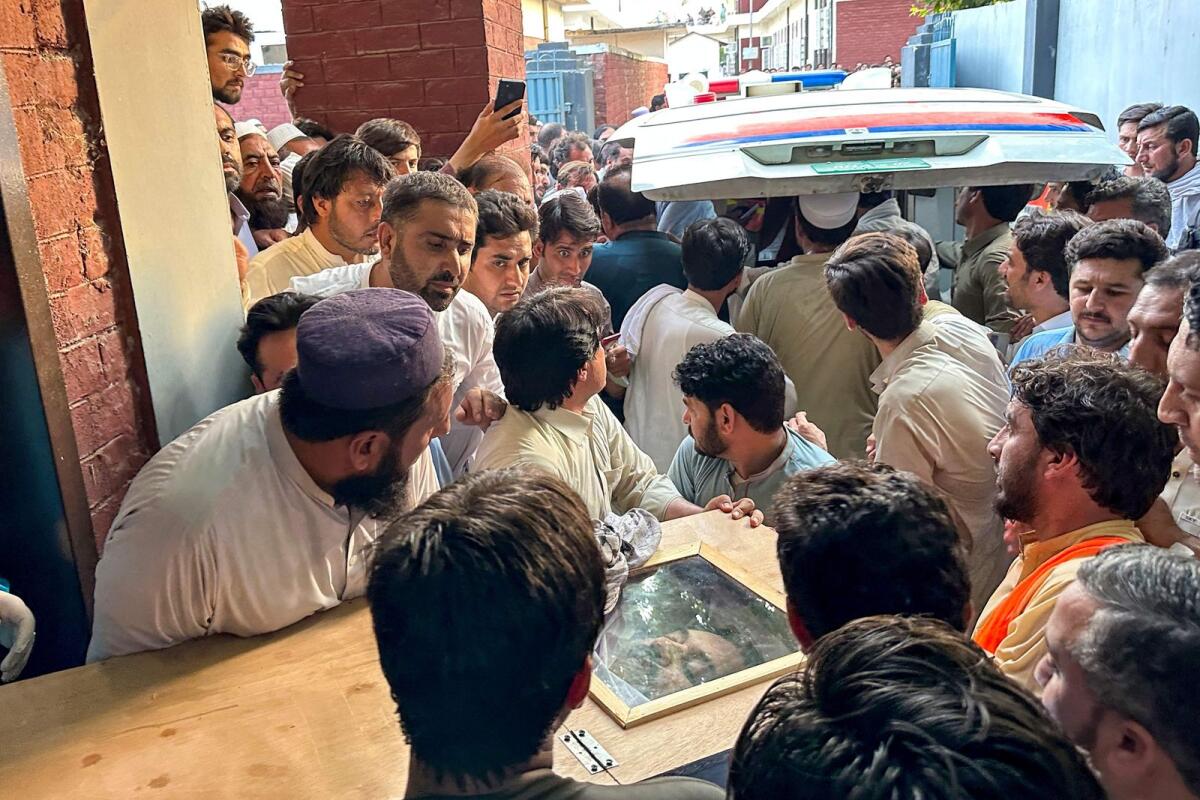 People carry the coffin of former senator Hidayatullah Khan to an ambulance after he was killed in a bomb explosion at Bajaur district of Pakistan's Khyber Pakhtunkhwa province on July 3, 2024. — AFP
