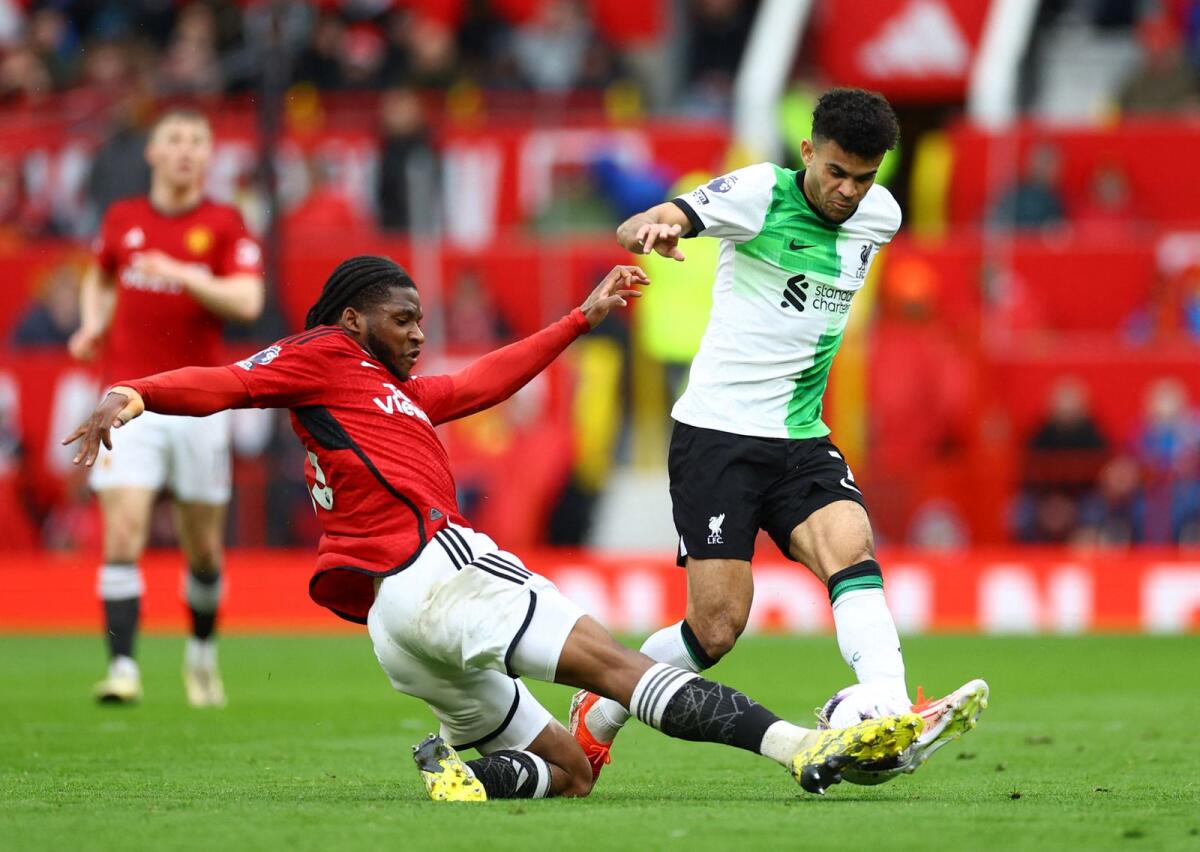 Manchester United's Willy Kambwala vies for the ball with Liverpool's Luis Diaz. — Reuters