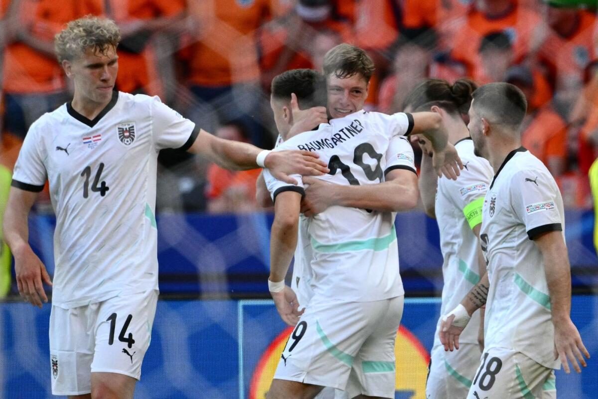Austria's Marcel Sabitzer celebrates with his teammates after scoring his team's third goal. — AFP