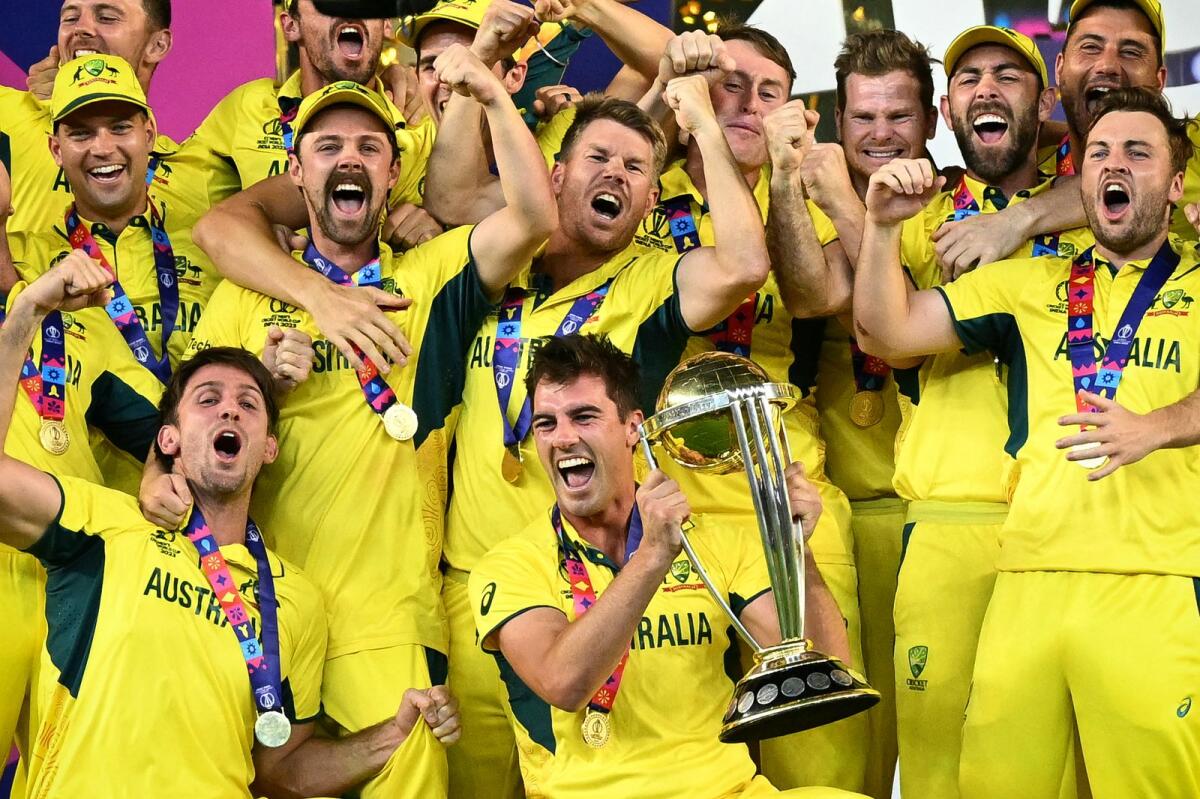 Australia's players celebrate with the trophy after winning the 2023 ODI World Cup on November 19, 2023. — AFP file