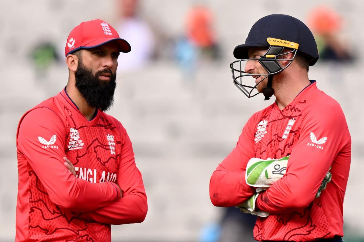 England captain Jos Buttler (right) with Moeen Ali. — AFP