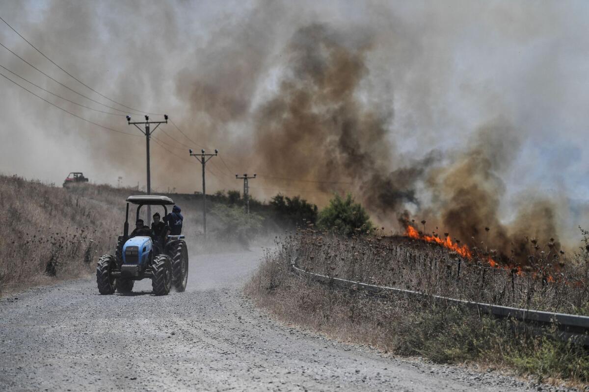 Fires blaze on the Israeli-occupied Golan Heights after Lebanon's Hezbollah said it launched more than 200 rockets and a swarm of drones at Israeli military sites on July 4. — Reuters
