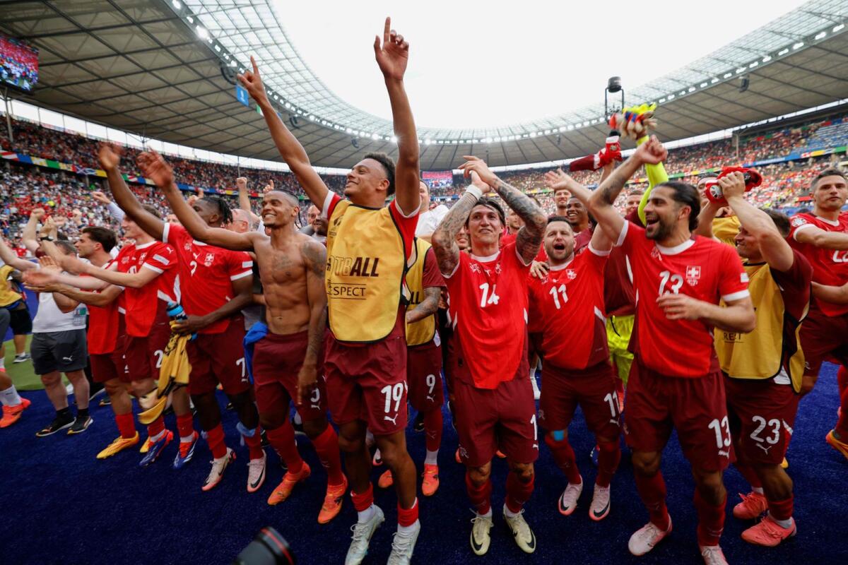Switzerland players celebrate their win over Italy. — AFP