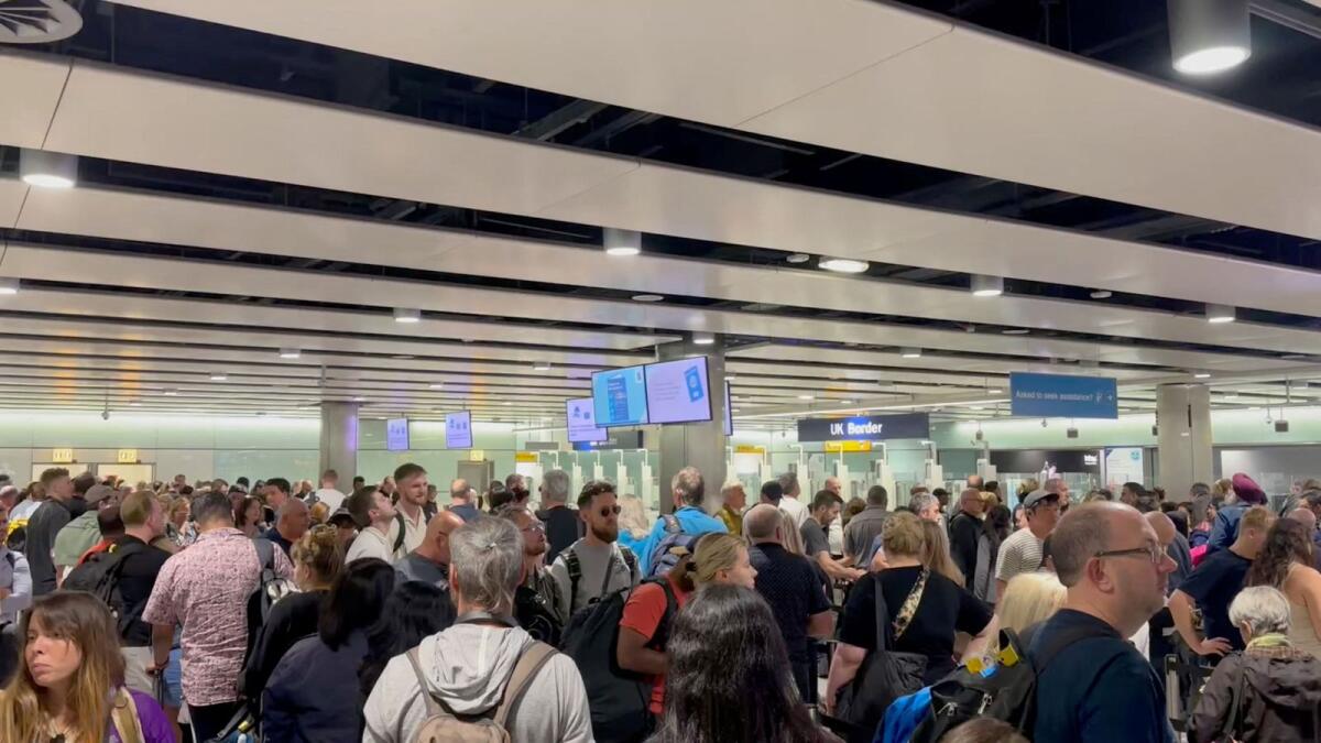 People wait in line at Heathrow airport, after the Border Force suffered a nationwide technical issue that affected passport control, in London, Britain, on Tuesday. — Reuters