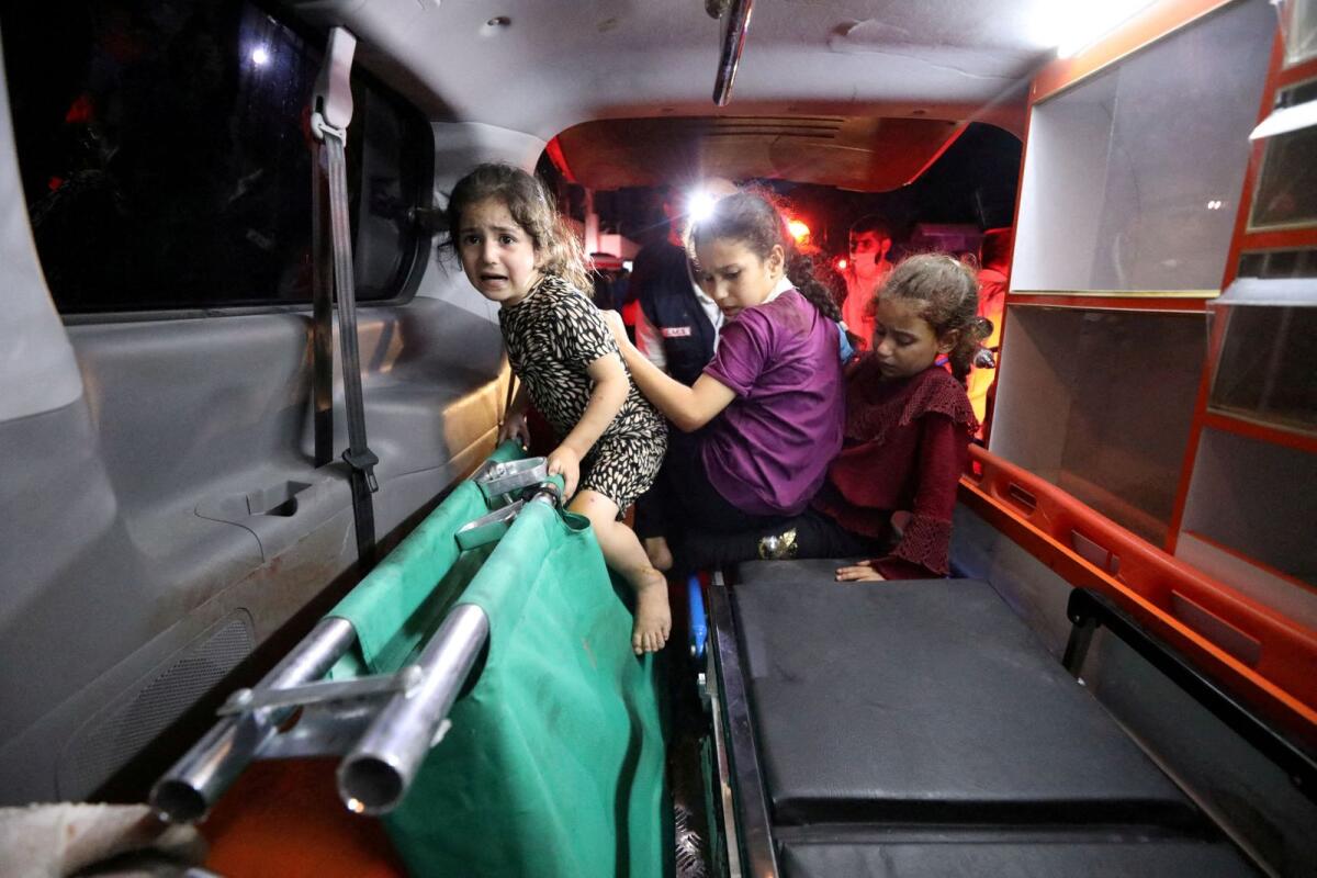 Children sit in the back of an ambulance at Shifa Hospital after hundreds of Palestinians were killed in a blast at Al-Ahli hospital. Photo: Reuters