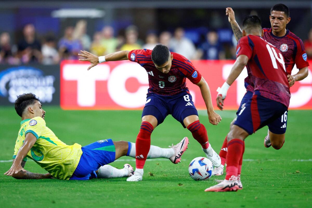 Lucas Paqueta of Brazil and Joseph Mora of Costa Rica battle for the ball. — AFP