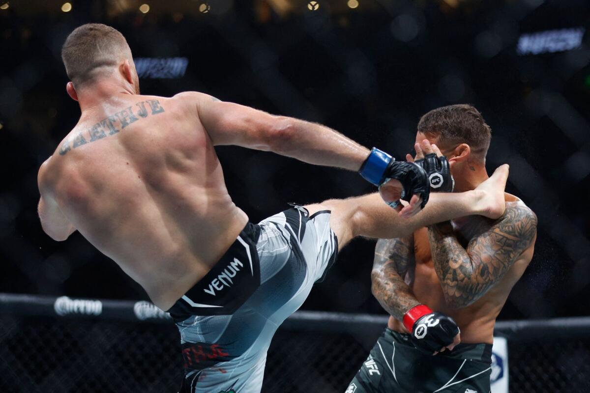 Justin Gaethje (blue gloves) lands the winning kick to the head of Dustin Poirier during UFC 291 on Saturday night. -  USA Today