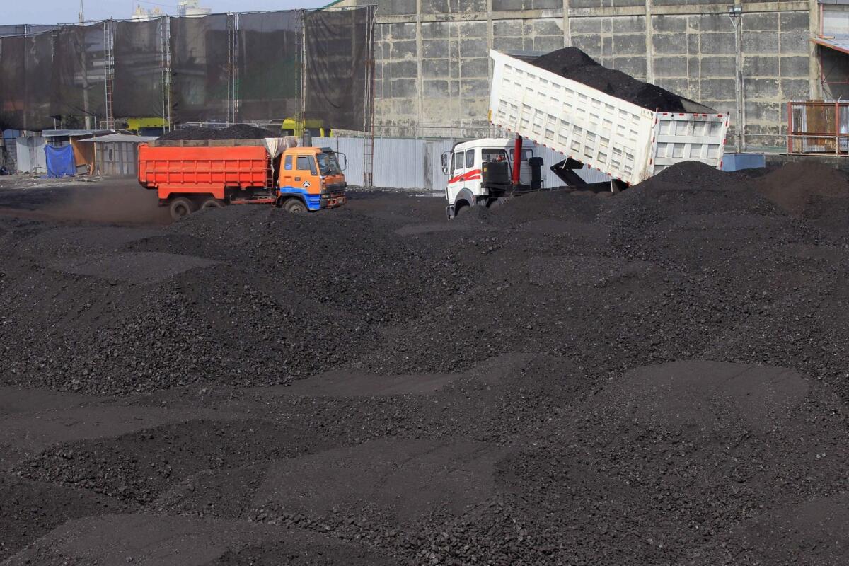 A truck unloads coal inside a warehouse in Tondo city, metro Manila. — Reuters file
