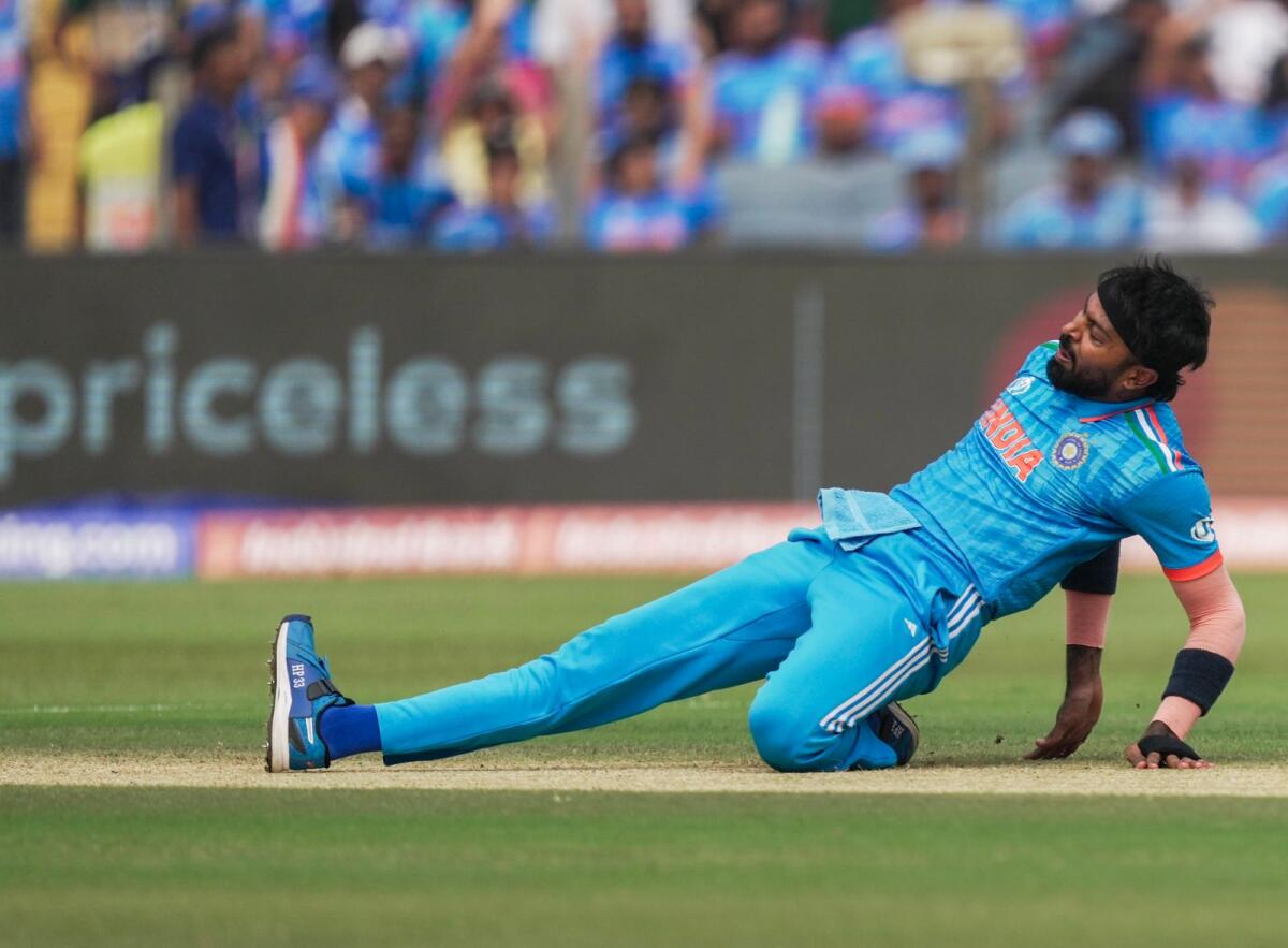 India's bowler Hardik Pandya attempts to stop the ball during the ICC Men's Cricket World Cup 2023 match between India and Bangladesh. Photo: PTI