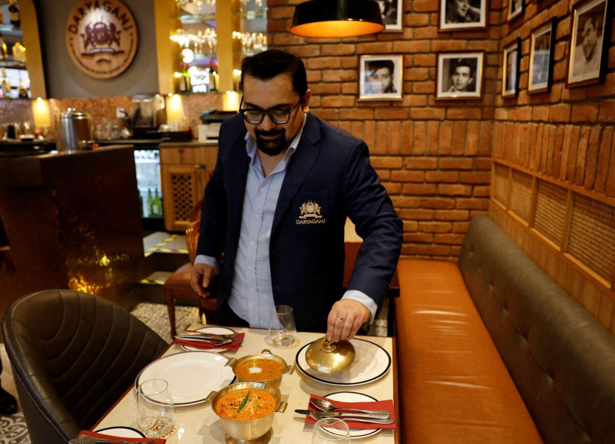 Amit Bagga, CEO of Daryaganj restaurant, shows freshly prepared butter chicken and dal Makhani in Noida, India. Photo: Reuters file