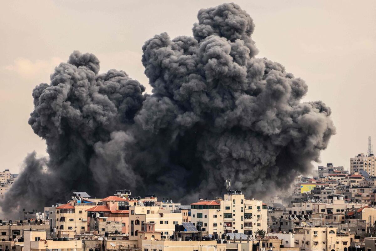 A plume of smoke rises in the sky of Gaza City during an Israeli airstrike on October 9, 2023. Photo: AFP