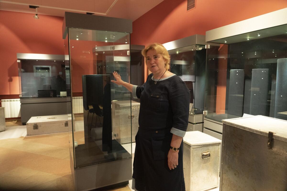 Natalia Panchenko, director of the Museum of Historical Treasures of Ukraine, shows empty showcases in Kyiv, Ukraine. Fearing Russian troops would storm the city, Panchenko dismantled exhibits, carefully packing away artefacts into boxes for evacuation.