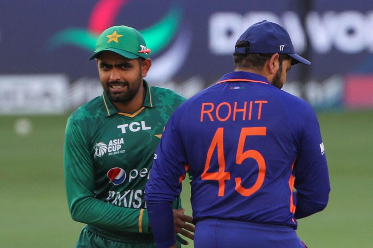 Pakistan captain Babar Azam (left) with Indian captain Rohit Sharma before the start of their Asia Cup match last year in Dubai. — AFP