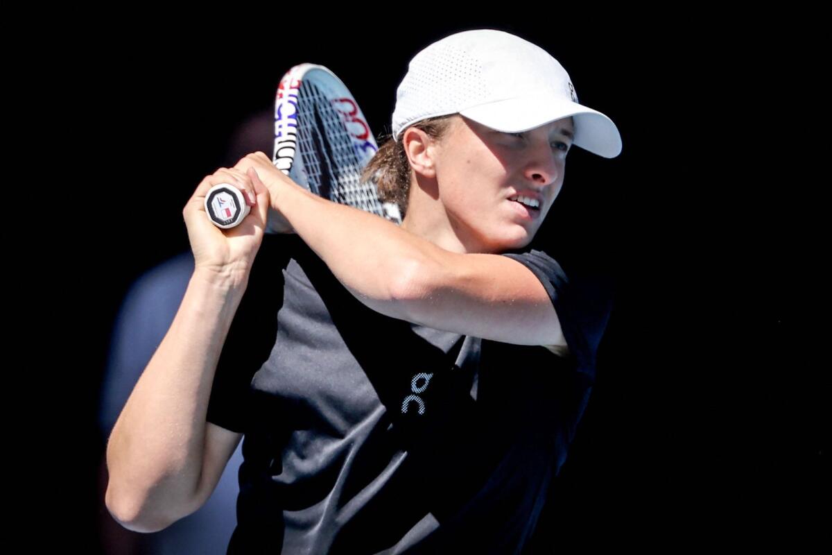 Poland’s Iga Swiatek hits a shot during a practice session on Rod Laver Arena in Melbourne on January 11, 2024. - AFP