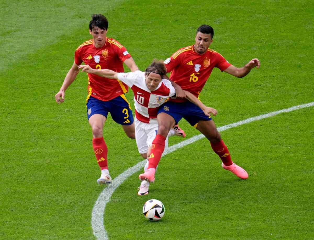 Croatia's Luka Modric (centre) fights for the ball during the team's 3-0 defeat to Spain. — Reuters