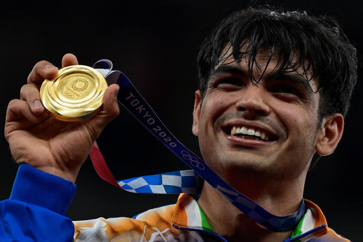 Neeraj Chopra of India celebrates on the podium after winning the gold medal in the  men's javelin throw event at the 2020 Tokyo Olympic Games. — AFP file