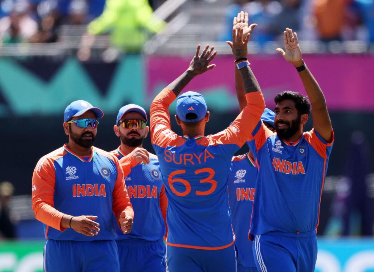 India's Jasprit Bumrah celebrates with team mates after taking the wicket of Pakistan's Babar Azam. Photo: Reuters