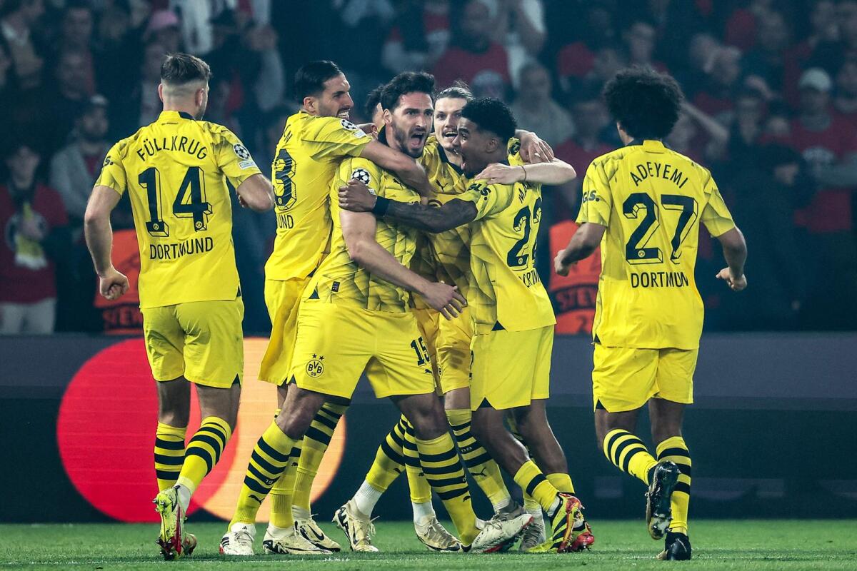 Dortmund defender Mats Hummels (centre) celebrates with teammates after scoring a goal. — AFP
