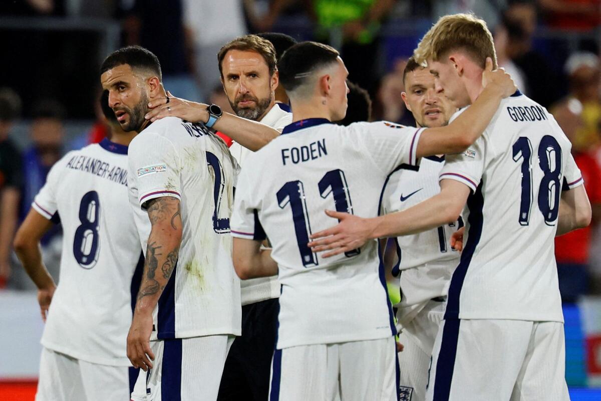 England manager Gareth Southgate with players after the match. — Reuters