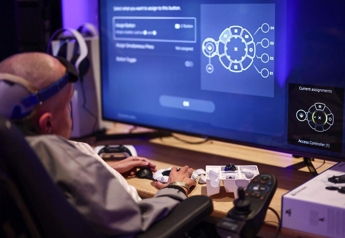 Jeremy Lecerf, also known as Mr Gyzmo, tries out the new Playstation Access controller at a demonstration event in London on October 5, 2023. — AFP