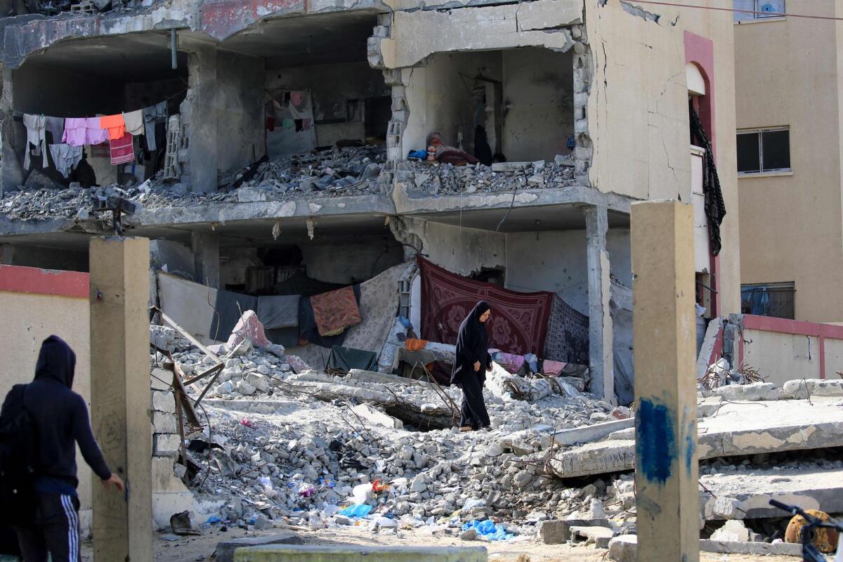 Palestinians inspect the damage after an Israeli airstrike in Rafah. Photo: AFP