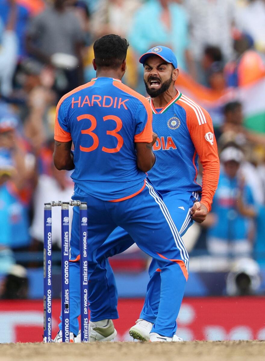Hardik Pandya celebrates with Virat Kohli after South Africa's David Miller was caught in the deep by Suryakumar Yadav off his bowling. — Reuters