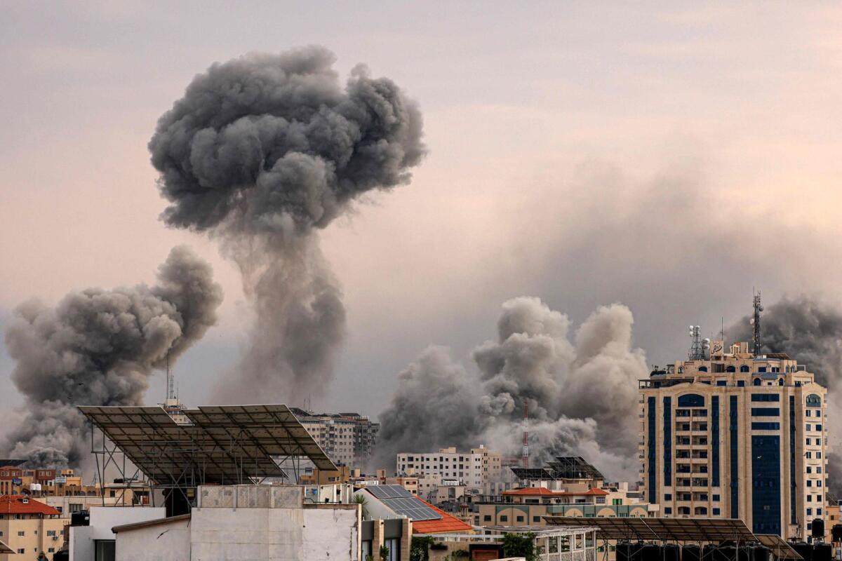A plume of smoke rises in the sky of Gaza City during an Israeli airstrike. — AFP