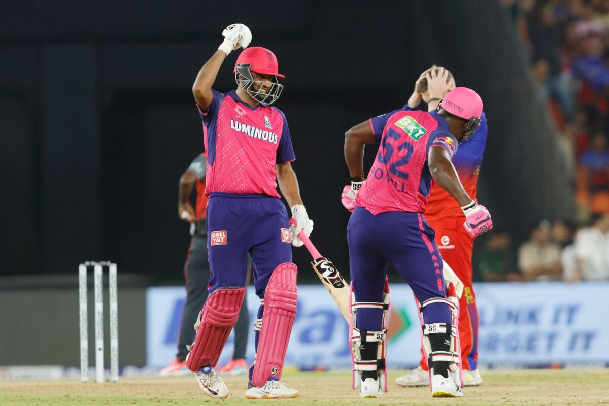 Rovman Powell and R. Ashwin of Rajasthan Royals celebrate the win over Royal Challengers Bengaluru. — IPL