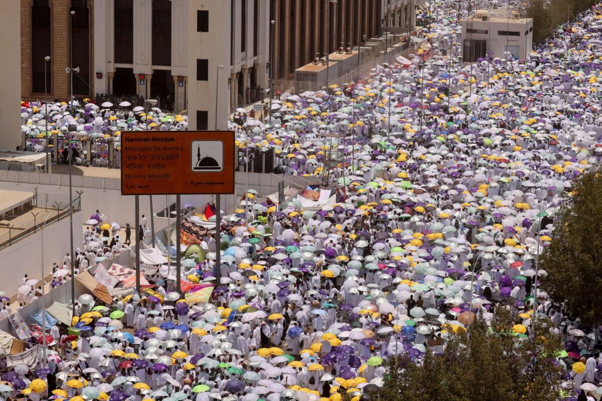 FILE. Muslim pilgrims carry umbrellas amid high temperatures outside Namira Mosque on the plain of Arafat during the annual Haj pilgrimage, outside the holy city of Makkah, Saudi Arabia. Photo: Reuters