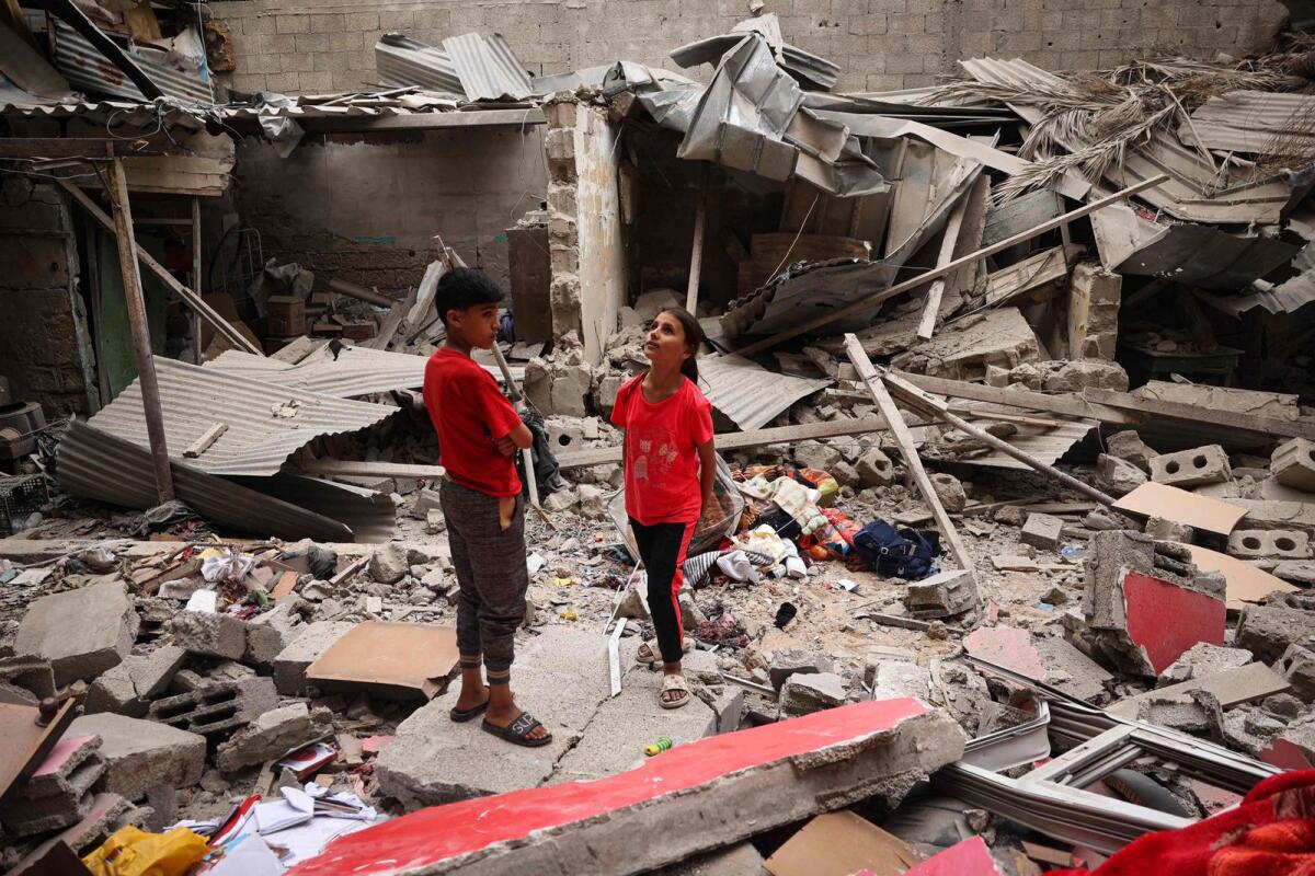 Palestinian children stand amid the debris of a house destroyed by overnight Israeli bombardment in Rafah in the southern Gaza Strip on April 27, 2024. — AFP