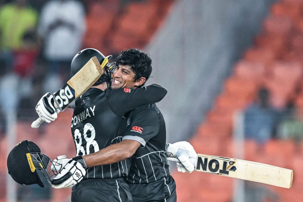 New Zealand's Rachin Ravindra (right) celebrates with Devon Conway after scoring a century against England. — AFP