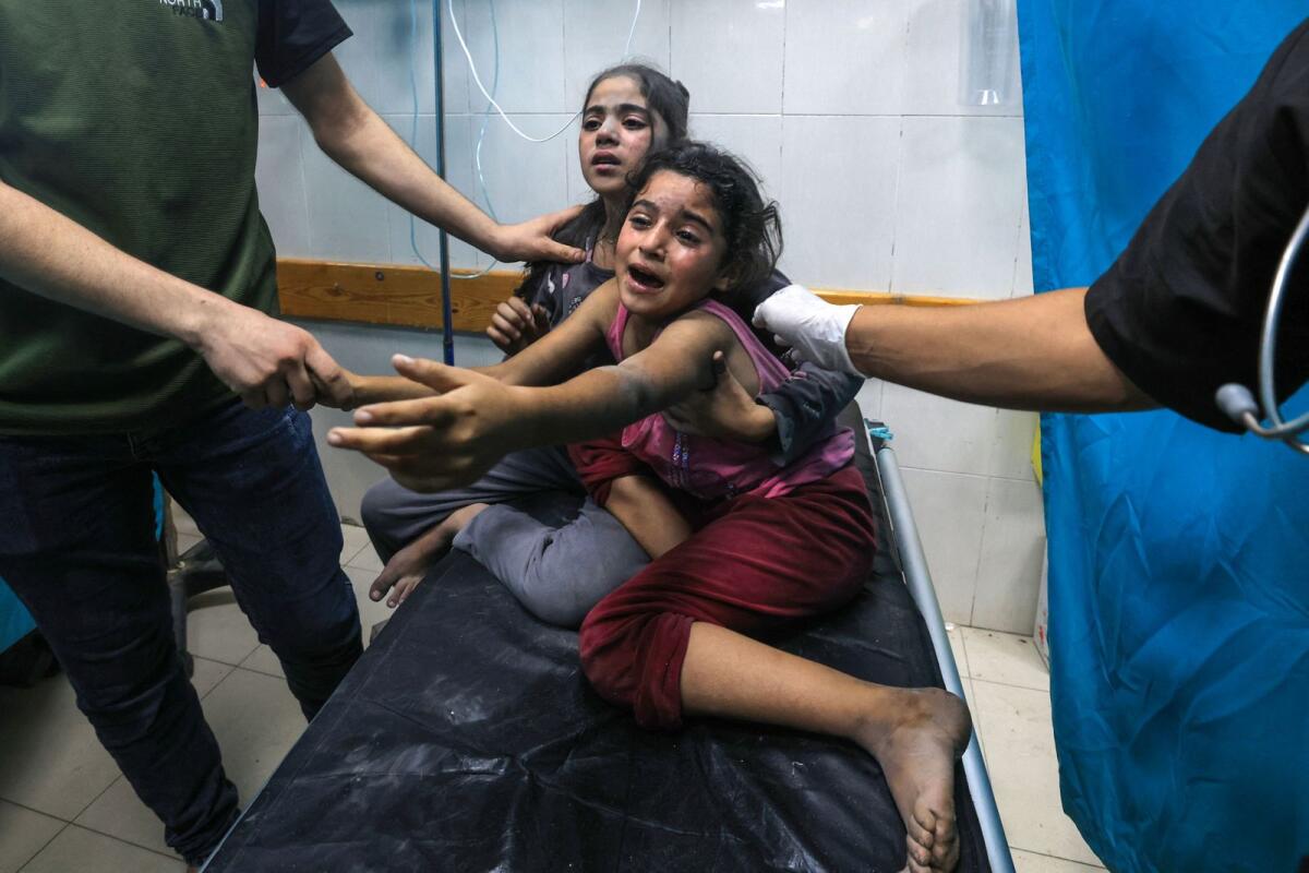 Children injured in an Israeli air strike react as they receive treatment in the Nasser hospital in Khan Yunis in the southern of Gaza Strip,. — AFP