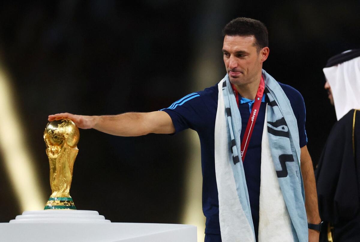 Argentina coach Lionel Scaloni touches the Fifa World Cup trophy after his team beat France in the 2022 final in Qatar. — Reuters