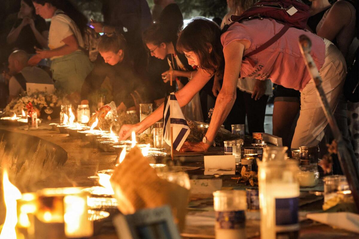 People light candles around the fountain at a vigil for the hostages taken by Palestinian militants during the October 7 attack, at Dizengoff Square (Kikar Dizengoff) in the centre of Tel Aviv on November 7, 2023.  Photo: AFP