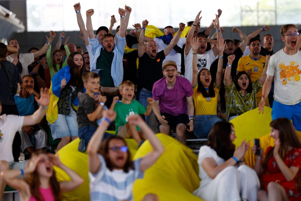Ukraine fans celebrate after watching the match at a market in Kiev. — Reuters