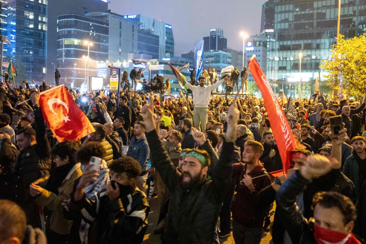People take part in a protest outside the Israeli Consulate to show solidarity with Palestinians, in Istanbul early on October 18, 2023. Photo: AFP