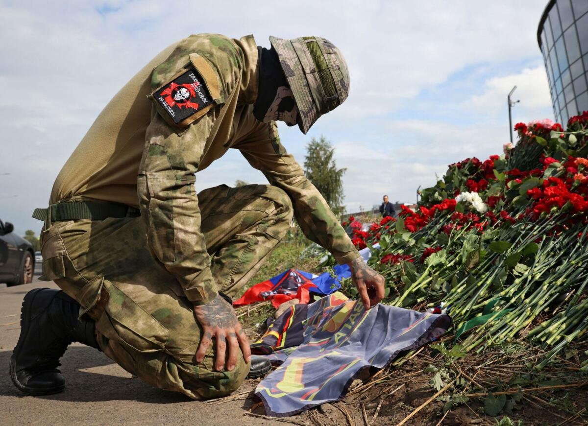 A fighter of Wagner private mercenary group visits a makeshift memorial near former PMC Wagner Centre, associated with the founder of the Wagner Group, Yevgeny Prigozhin, in Saint Petersburg, Russia, on Thursday. — Reuters