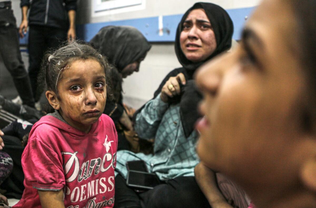 Wounded Palestinians at the Al Shifa hospital following Israeli airstrikes in Gaza City. — AP