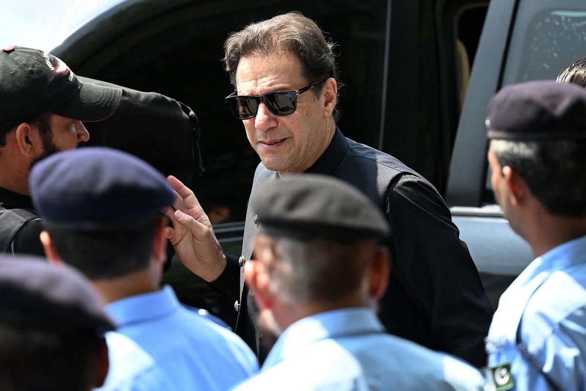 Pakistan’s former Prime Minister Imran Khan (C) arrives to appear in the Supreme Court in Islamabad on July 24, 2023.  Photo: AFP