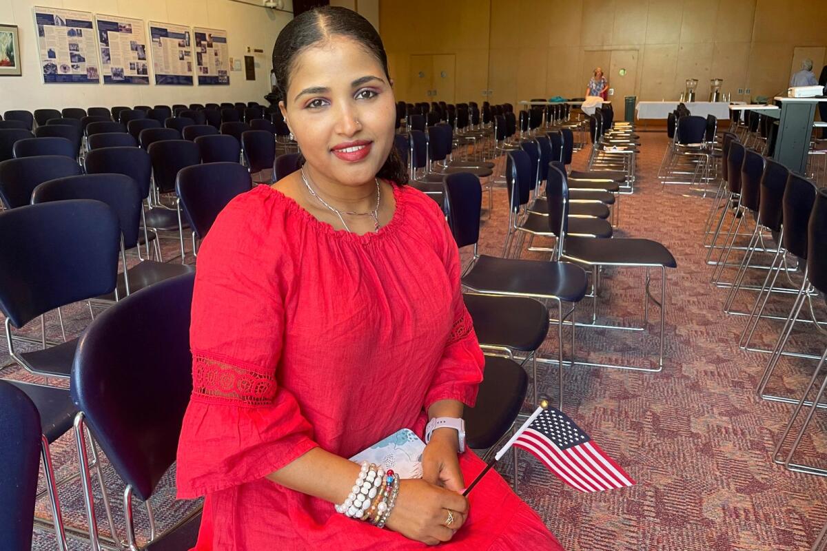Heaven Mehreta, 32, smiles and holds a small American flag inside Mount Zion Temple in St. Paul, Minn., June 21, 2023, after becoming a US citizen at a naturalisation ceremony that day in the synagogue. Mehreta immigrated from Ethiopia 10 years ago, learned English as an adult and passed the US citizenship test in May. -- AP