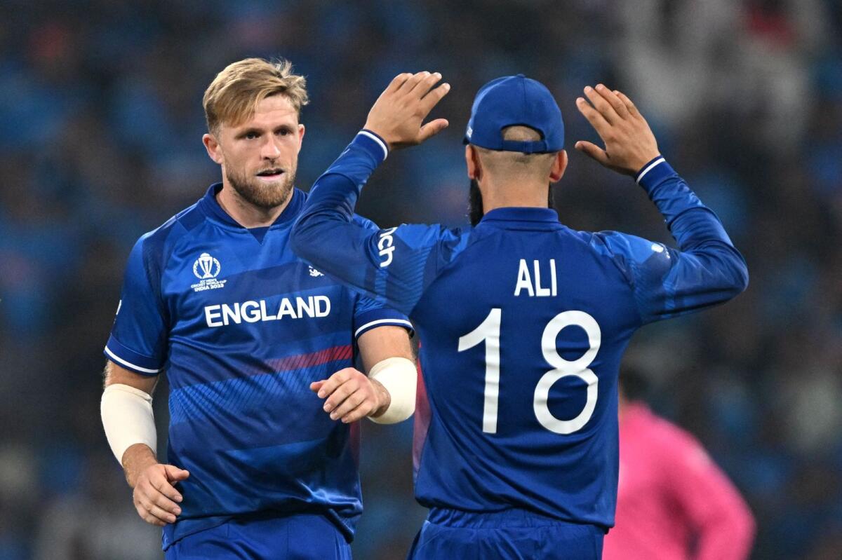 England's David Willey (L) celebrates with teammate Moeen Ali . - AFP