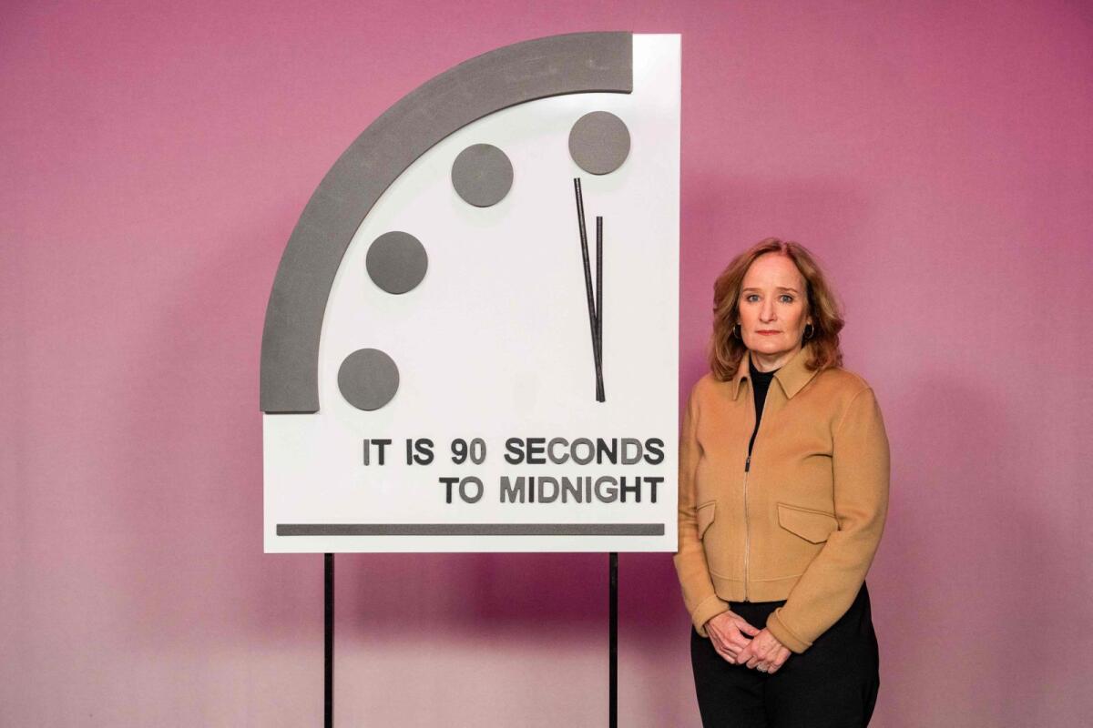 Rachel Bronson, president and CEO of the Bulletin of Atomic Scientists, stands next to the Doomsday Clock that reads '90 seconds to midnight,' a decision made by The Bulletin of Atomic Scientists, during an announcement in Washington, DC. — AFP