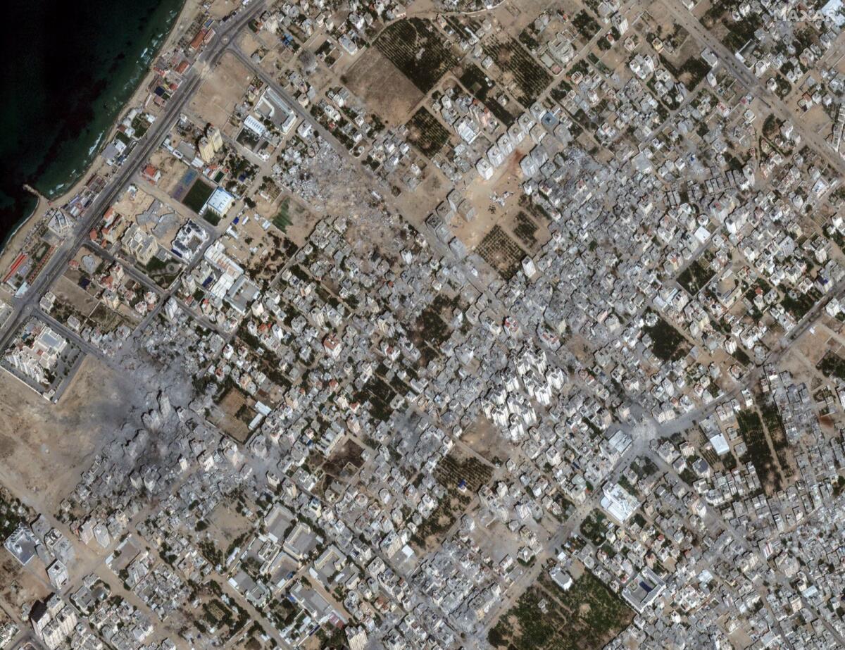 This image provided by Maxar Technologies shows damages to buildings and structures after bombing at Al Karameh neighbourhood, northern Gaza, on October 21, 2023. — AP