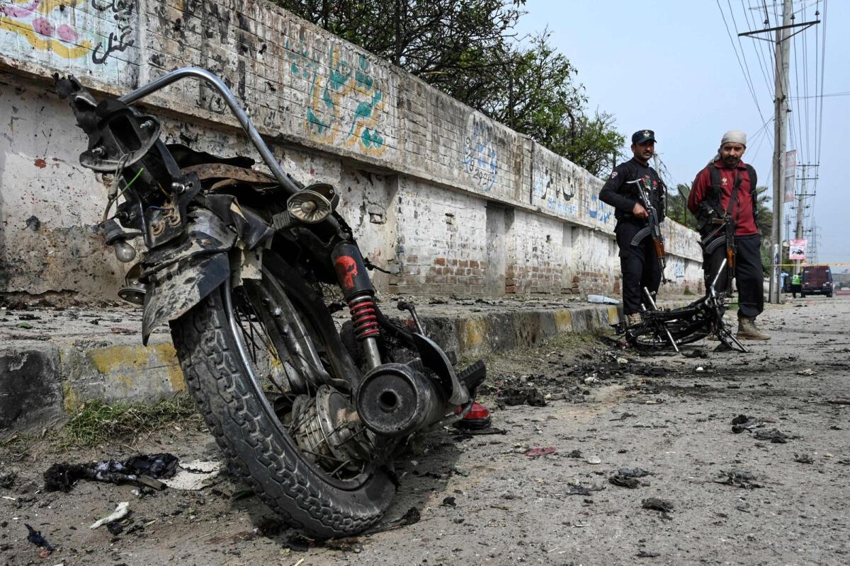 Security personnel examine the site of a blast in Peshawar district of the Khyber Pakhtunkhwa province on March 10, 2024. — AFP file
