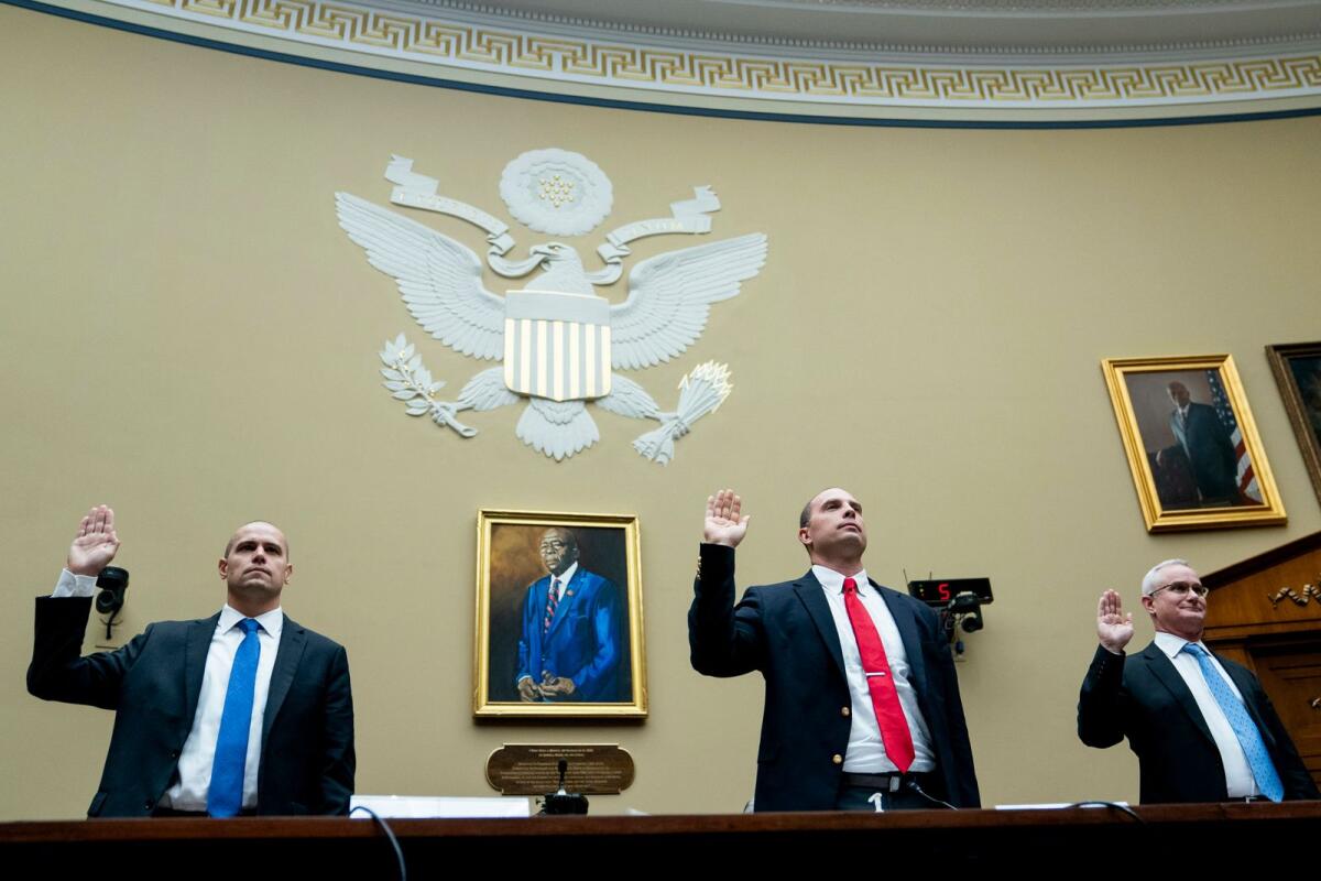 Ryan Graves, Americans for Safe Aerospace Executive Director, from left, US Air Force (Ret.) Maj. David Grusch, and US Navy (Ret.) Cmdr. David Fravor, are sworn in during a House Oversight and Accountability subcommittee hearing on UFOs, on Wednesday,. -- AP