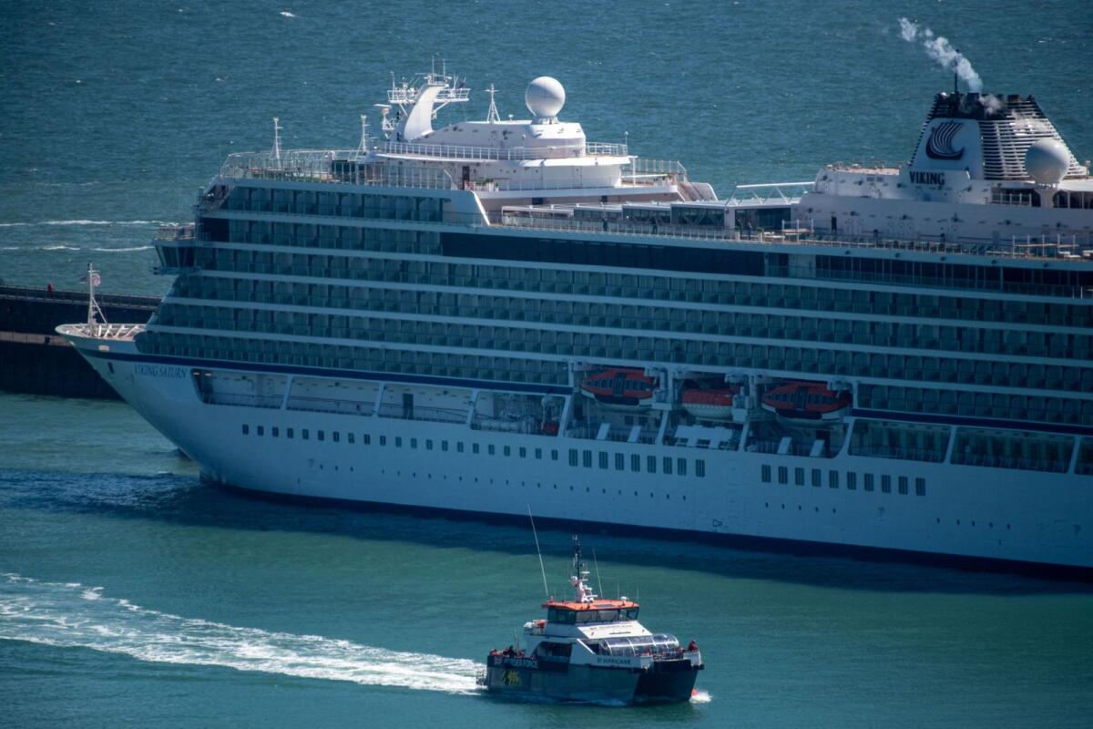 A British Border Force vessel carrying people believed to be migrants passes by a cruise ship as it arrives at the Port of Dover in Dover in Britain on April, 29, 2024. — Reuters