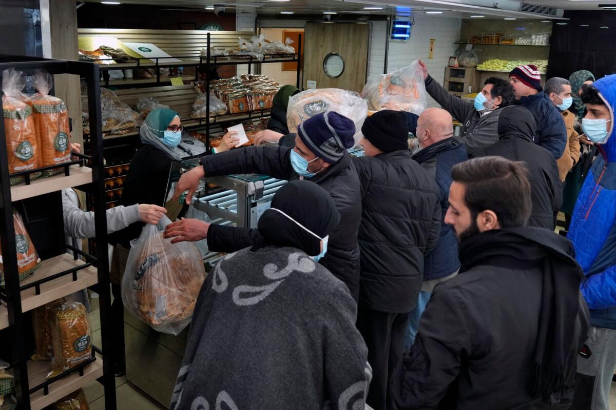 People queue for bread inside a bakery in the southern Beirut suburb of Dahiyeh, Lebanon on March 15, 2022. -- AP file