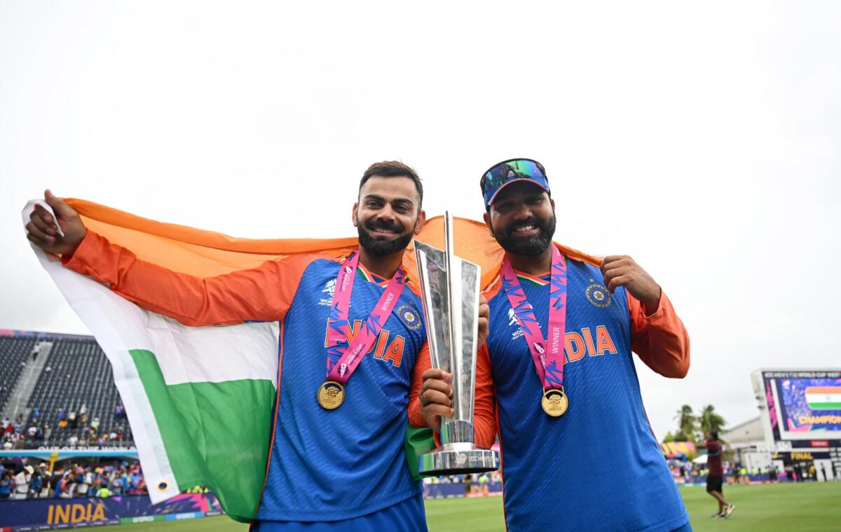 Virat Kohli and Rohit Sharma celebrate with the trophy. — X